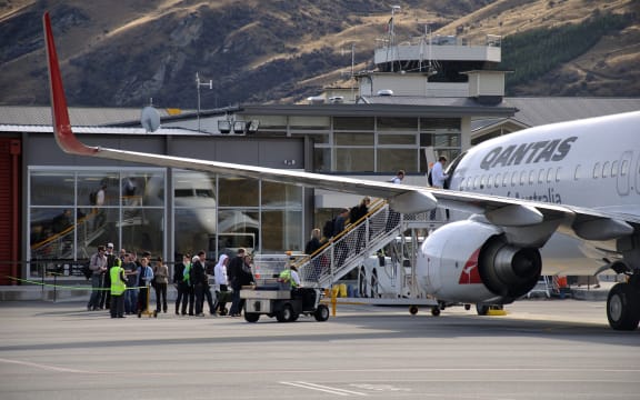 Passengers board commercial jet at Queenstown Airport.