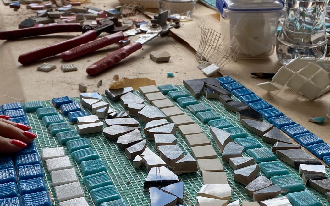 Every Saturday in November, Muriwai locals are making mosaics out of pieces of homes wrecked during Cyclone Gabrielle.