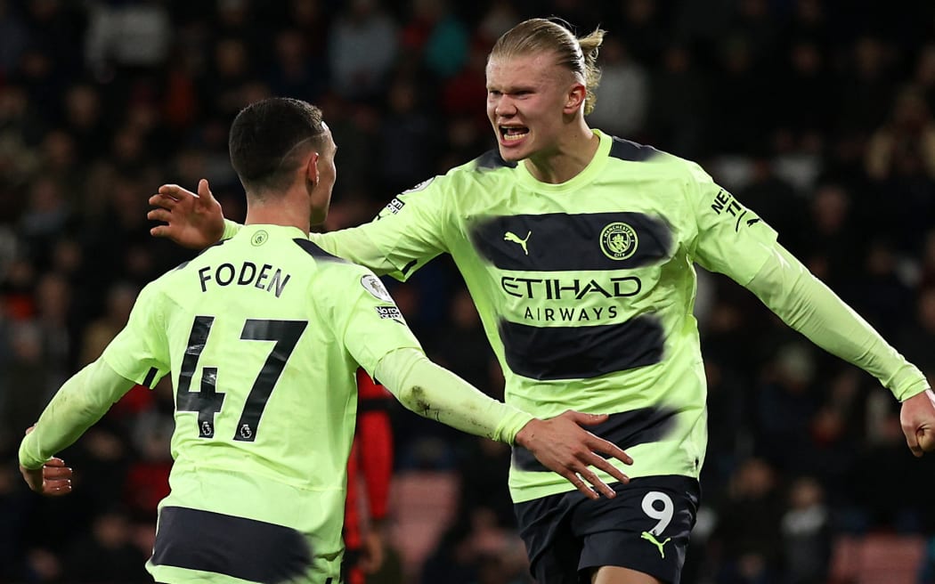 Manchester City's English midfielder Phil Foden (L) celebrates scoring his team's third goal with Manchester City's Norwegian striker Erling Haaland (R) during the English Premier League football match between Bournemouth and Manchester City at the Vitality Stadium in Bournemouth, southern England on February 25, 2023. (Photo by ADRIAN DENNIS / AFP) / RESTRICTED TO EDITORIAL USE. No use with unauthorized audio, video, data, fixture lists, club/league logos or 'live' services. Online in-match use limited to 120 images. An additional 40 images may be used in extra time. No video emulation. Social media in-match use limited to 120 images. An additional 40 images may be used in extra time. No use in betting publications, games or single club/league/player publications. /