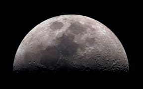 Moon, view through a telescope. The moon with craters. Real photos of space objects through a telescope. Natural background.