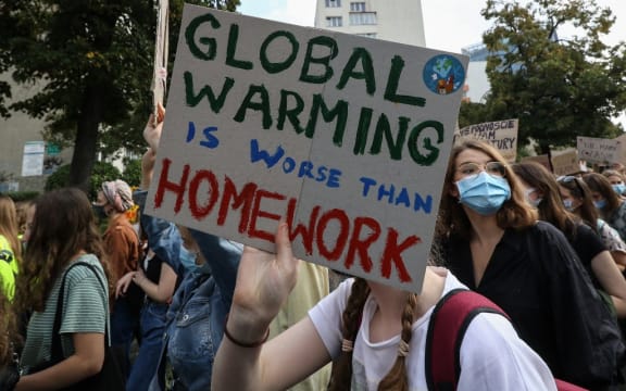 Young protesters with pro-climate banners are seen in Gdansk, Poland, on 25 September 2020