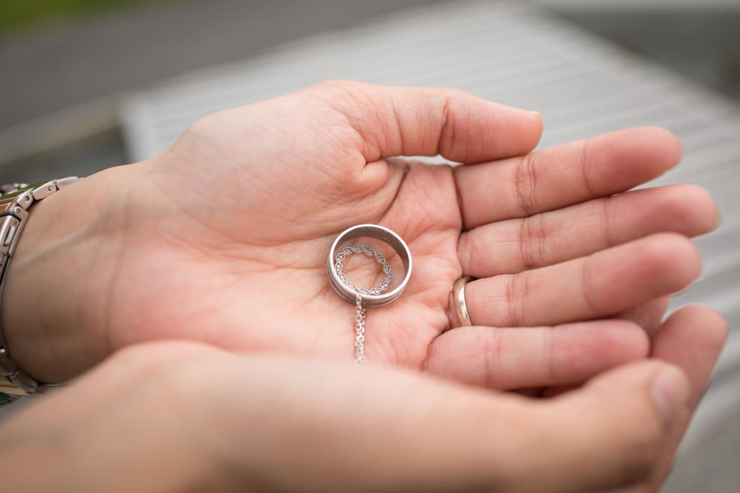 Farah holds a pendant, a special present from Atta symbolizing their never-ending love. This, and Atta's wedding ring remain with Farah at all times.