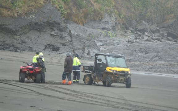 Locals and Landsar personnel at Kiritehere Beach where Thomas Phillips' car was found on Saturday