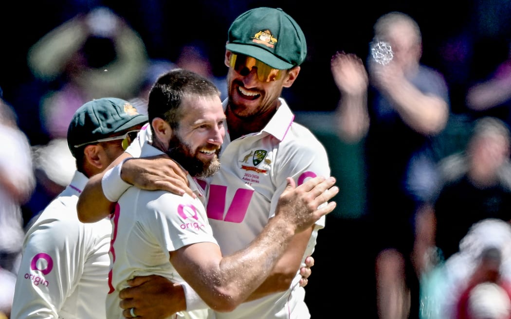Australia's Michael Neser (L) celebrates with teammate Mitchell Starc after taking the wicket of England's Joe Root on day two of the fifth Ashes cricket Test between Australia and England at the Sydney Cricket Ground in Sydney on January 5, 2026. (Photo by Saeed KHAN / AFP) / -- IMAGE RESTRICTED TO EDITORIAL USE - STRICTLY NO COMMERCIAL USE --