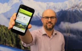 Operations manager Nathan Watson holding the app.
