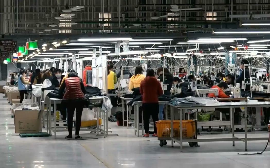 Workers at the factory sew merino into garments.