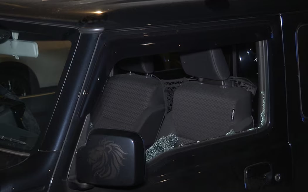 The window of a car was shattered during what witnesses described as a "volley of gunshots".
