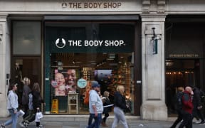 Pedestrians pass a branch of The Body Shop on Regent Street in central London on February 12, 2024. The Body Shop, the near 50-year-old cosmetics company renowned for its ethical hair and skin products, is near bankrupt in the UK after poor Christmas trade, according to reports in British media. (Photo by Daniel LEAL / AFP)