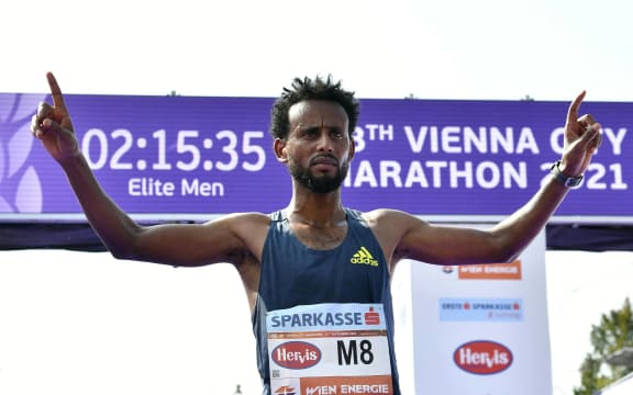 Ethiopia's Derara Hurisa celebrates in the finish area during the 38th edition of the Vienna City Marathon in Vienna, Austria, on September 12, 2021. He was later disqualified for wearing illegal shoes.