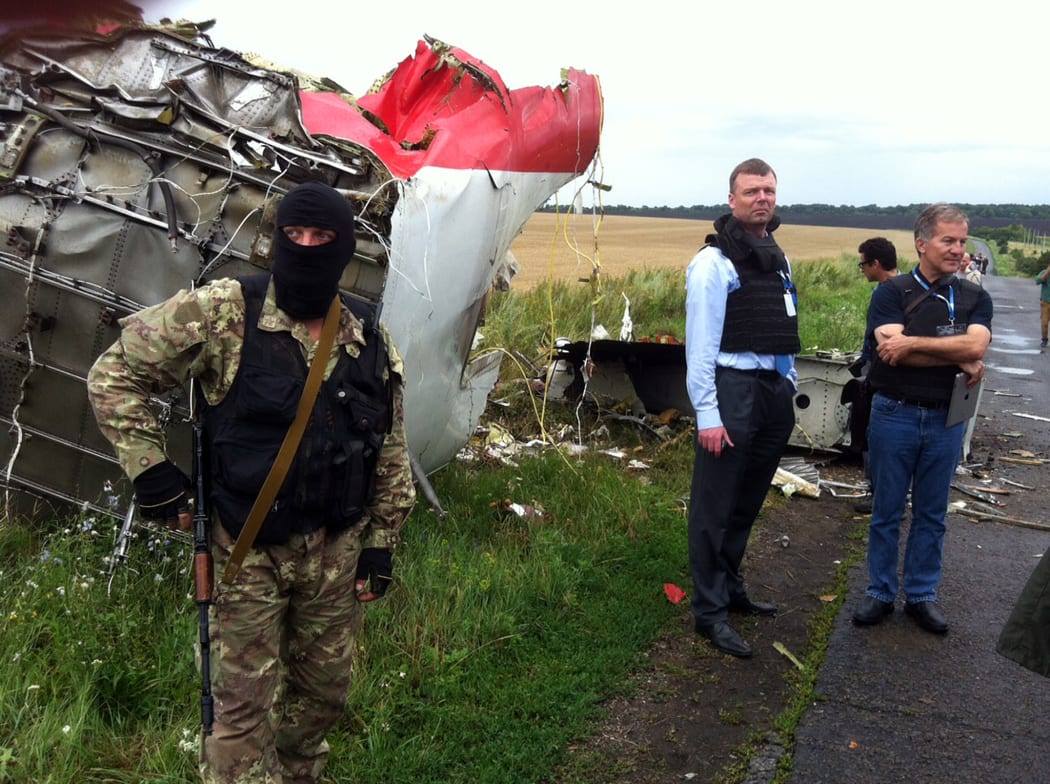 Alexander Hug (2nd L) of the OSCE mission to Ukraine visits the crash site.