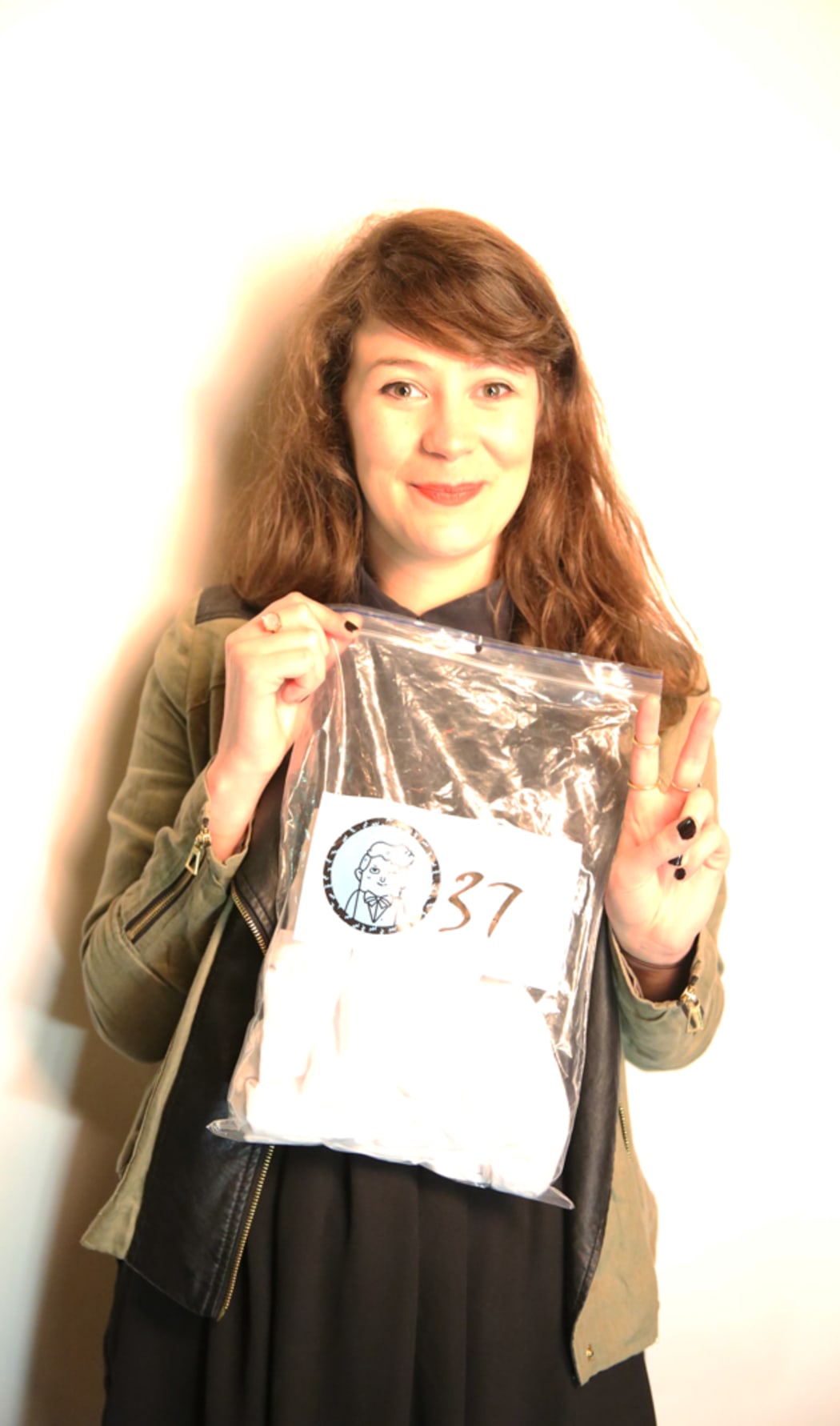 A picture of Julia Hollingsworth holding a bagged T-shirt labelled #37
