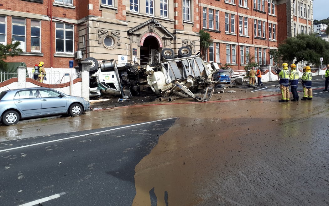 Mud, oil and water covered the road after the crash on upper Stuart Street.
