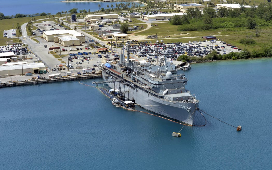 This image obtained from the US Department of Defense shows the  submarine tender USS Emory S. Land and the Los Angeles-class attack submarine USS Topeka pierside in their home port at Polaris Point, Guam, on April 19, 2017. The United States on August 9, 2017, warned North Korea that the pursuit of its nuclear drive could lead to the collapse of Kim Jong-Un's regime, as US President Donald Trump brandished America's nuclear might as a powerful deterrent. North Korea said that it is considering strikes near US installations in Guam with its intermediate range ballistic missiles, state news agency KCNA reported. (Photo by Jamica Johnson / US NAVY / AFP) / RESTRICTED TO EDITORIAL USE - MANDATORY CREDIT "AFP PHOTO / US NAVY / Petty Officer 1st Class Jamica Johnson" - NO MARKETING NO ADVERTISING CAMPAIGNS - DISTRIBUTED AS A SERVICE TO CLIENTS