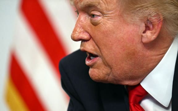 US President Donald Trump participates in a video call with military service members from his Mar-a-Lago residence in Palm Beach, Florida, on November 27, 2025, during the Thanksgiving holiday. US President Donald Trump said Thursday that Sarah Beckstrom, one of the two National Guard troops shot a day earlier near the White House, had died, while the other soldier was "fighting for his life." (Photo by Jim WATSON / AFP)