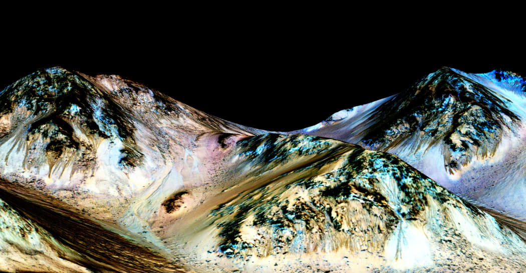 Dark, narrow 100m long streaks, called recurring slope lineae, flowing downhill on Mars, inferred to have been formed by contemporary flowing water.