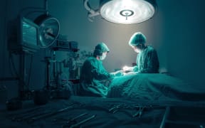 Surgeons team working with Monitoring of patient in surgical operating room.