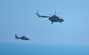 Chinese military helicopters fly past Pingtan island, one of mainland China's closest point from Taiwan, in Fujian province on August 4, 2022, ahead of massive military drills off Taiwan.