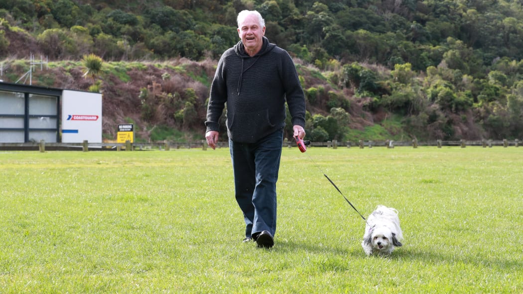Picton man Fredrick Wilson walks his dog Milly at Picton’s Memorial Park, which he fears residents will be unable to do if it’s made a freedom camping site.