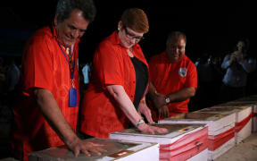 French Polynesian President Edouard Fritch, (left), and Australian Foreign Minister, Marise Payne, leave their handprints during the signing of the Boe Declaration