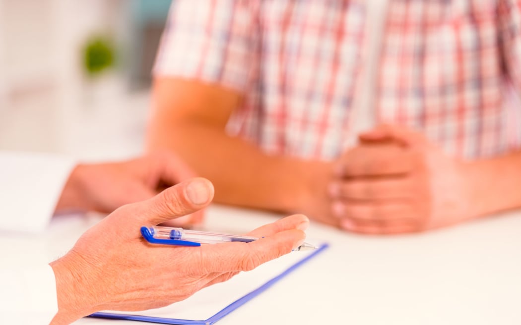 A doctor gives a male patient an update on his case (file photo)