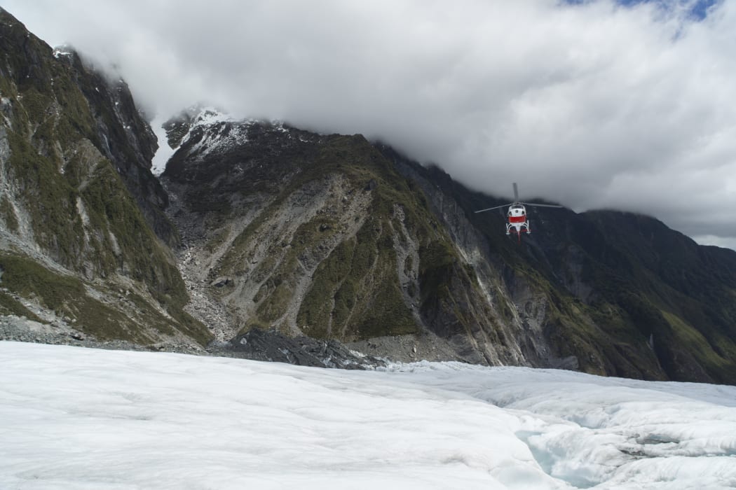 Helicopter landing on Franz Josef Glacier, South Island.