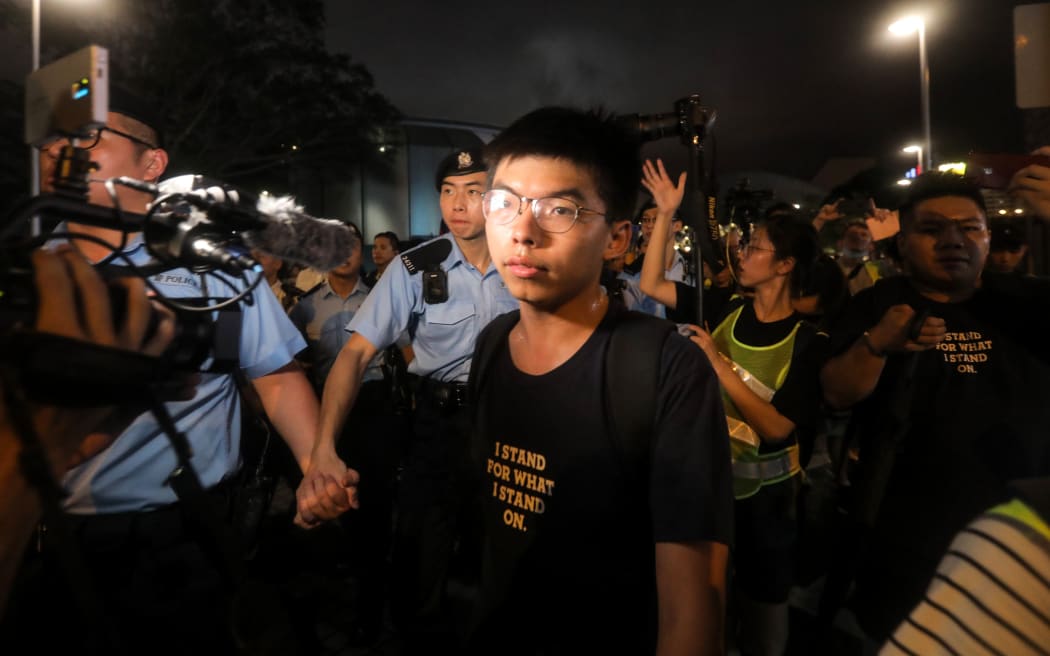 July 7, 2019, pro-democracy activist Joshua Wong confronts police after taking part in a march to the West Kowloon rail terminus against the proposed extradition bill in Hong Kong.