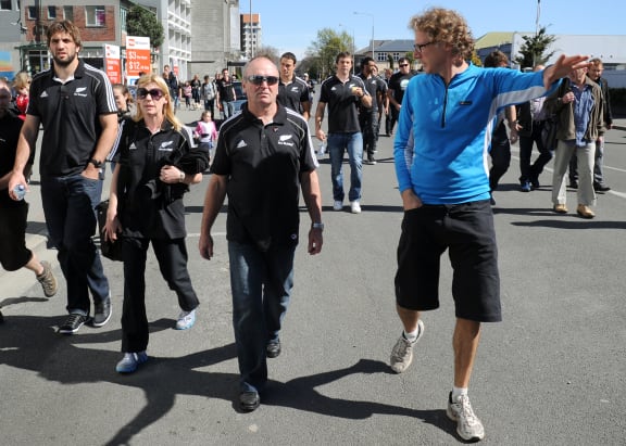 Roger Sutton (right), chief executive of the Canterbury Earthquake Recovery Authority (CERA) gives a New Zealand All Black coach Graham Henry (centre) and other All Blacks a tour of the devastation caused by the 22 February earthquake, in Christchurch on September 18, 2011.