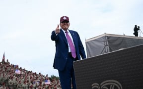 US President Donald Trump gives a thumbs up as he speaks at Fort Bragg, a US Army military installation, near Fayetteville, North Carolina, on June 10, 2025. (Photo by Brendan SMIALOWSKI / AFP)
