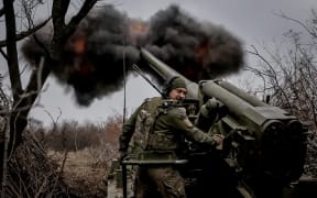 A serviceman of 24th Mechanised Brigade of the Ukrainian Armed Forces fires a 2s5 "Hyacinth-s" self-propelled howitzer towards Russian troops at a front line.