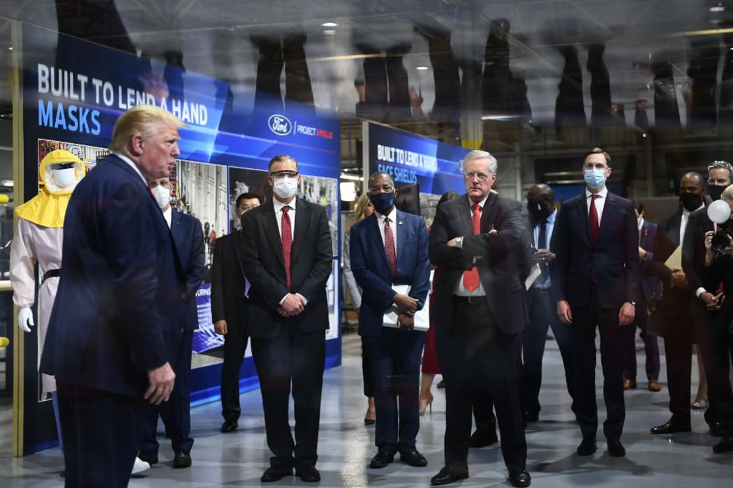 US President Donald Trump (L) speaks during a tour at the Ford Rawsonville Plant, that has been converted to making personal protection and medical equipment, in Ypsilanti, Michigan on May 21, 2020.