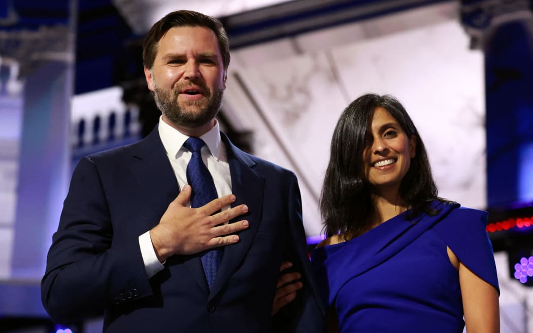 MILWAUKEE, WISCONSIN - JULY 17: Republican vice presidential candidate, U.S. Sen. J.D. Vance (R-OH) is joined by his wife Usha Chilukuri Vance on stage on the third day of the Republican National Convention at the Fiserv Forum on July 17, 2024 in Milwaukee, Wisconsin. Delegates, politicians, and the Republican faithful are in Milwaukee for the annual convention, concluding with former President Donald Trump accepting his party's presidential nomination. The RNC takes place from July 15-18.   Joe Raedle/Getty Images/AFP (Photo by JOE RAEDLE / GETTY IMAGES NORTH AMERICA / Getty Images via AFP)