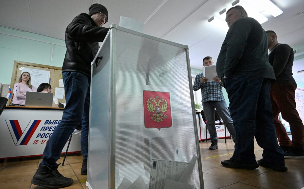 A man casts his ballot in Russia's presidential election at a polling station in Moscow on March 15, 2024.
