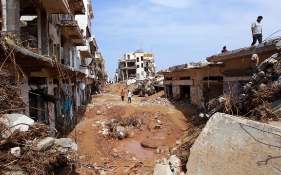 People check an area damaged by flash floods in Derna, eastern Libya, on September 11, 2023. Flash floods in eastern Libya killed more than 2,300 people in the Mediterranean coastal city of Derna alone, the emergency services of the Tripoli-based government said on September 12. (Photo by AFP)