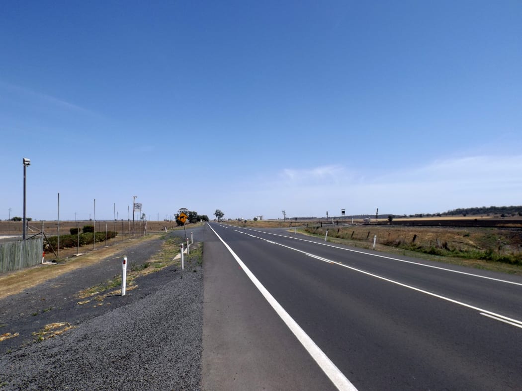 A British backpacker was pulled over on Queensland's Warrego Highway, with her alleged attacker hiding in a small alcove of the car.