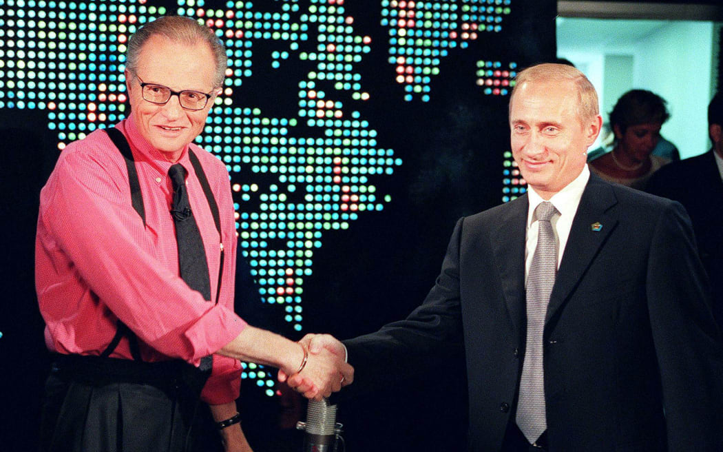(FILES) In this file photo taken on September 07, 2000, Russian President Vladimir Putin (R) shakes hands with CNN interviewer Larry King before the start his interview in New York.