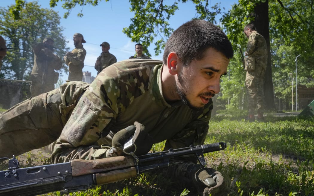 Newly recruited soldiers of the 3rd assault brigade train in Kyiv, Ukraine, Friday, May 17, 2024. A divisive mobilisation law in Ukraine came into force on Saturday, as Kyiv struggles to boost troop numbers after Russia launched a new offensive.