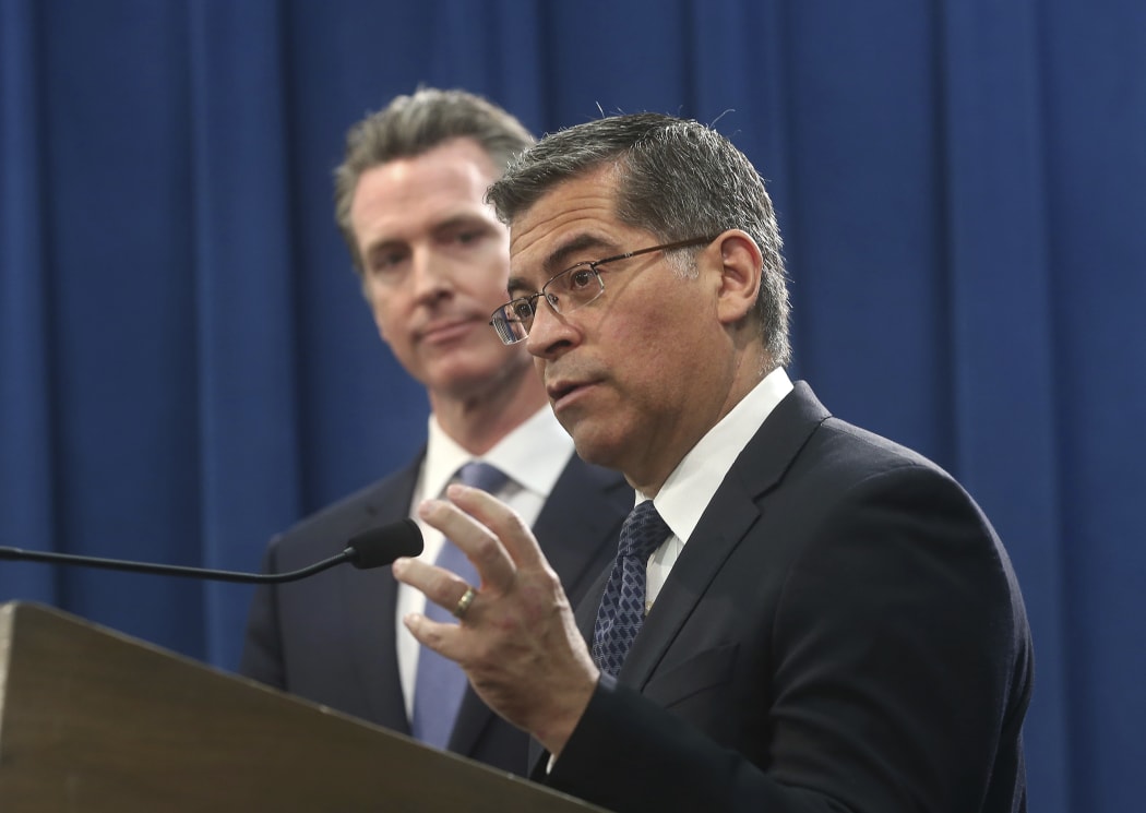 California Attorney General Xavier Becerra, right, accompanied by Gov. Gavin Newsom, said California will probably sue President Donald Trump over his emergency declaration to fund a wall on the U.S.-Mexico border