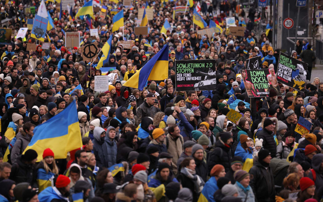 Demonstrators waving flags of Ukraine attend a demonstration in support of Ukraine, on Karl-Marx-Allee in Berlin, on February 24, 2023, the first anniversary of Russia's invasion of Ukraine. (Photo by Odd ANDERSEN / AFP)