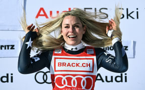 First-placed US Lindsey Vonn celebrates after winning the women's downhill at the FIS Alpine Ski World Cup 2025-2026, in St Moritz, Switzerland on December 12, 2025. (Photo by Fabrice COFFRINI / AFP)