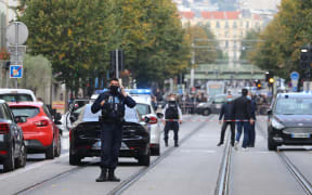 French policemen stand guard a street after a knife attack in Nice.