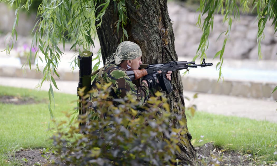 An armed pro-Russian militant standing guard in the eastern Ukrainian city of Donetsk.