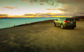 pukaki lake new zealand - august 31,2015 : tourist car parking on pukaki lake parking field beside road to auraki - mt.cook national park new zealand