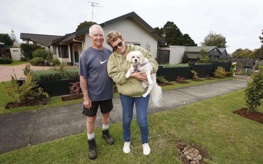 Terry and Jan Knight alongside what's left of one of the magnolias on their berm, after Terry cut it down in December and is now facing a $500-plus council fine