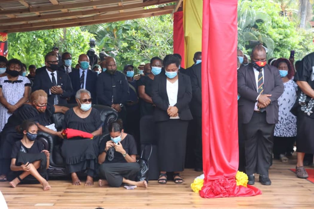 Lady Veronica Somare (seated in chair), along with family members and dignitiaries including PNG Prime Minister James Marape (standing on the right) attend the final burial of Sir Michael Somare in Wewak.