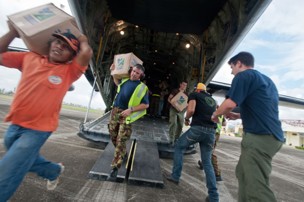 Aid is unloaded from a C-130 Hercules.