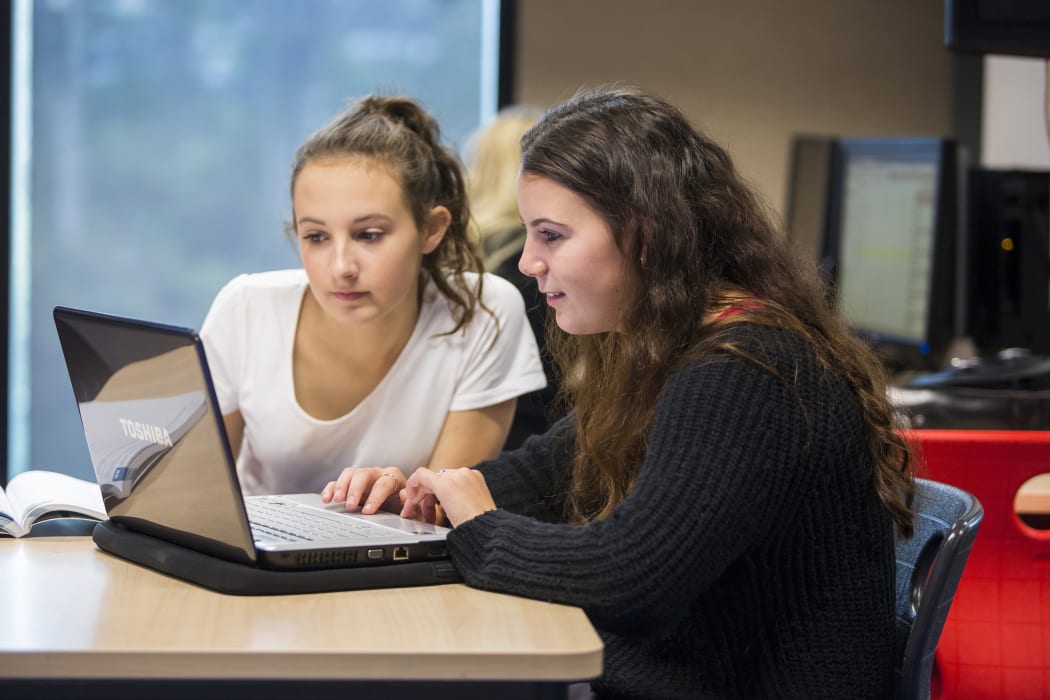 Stock photo of students using technology