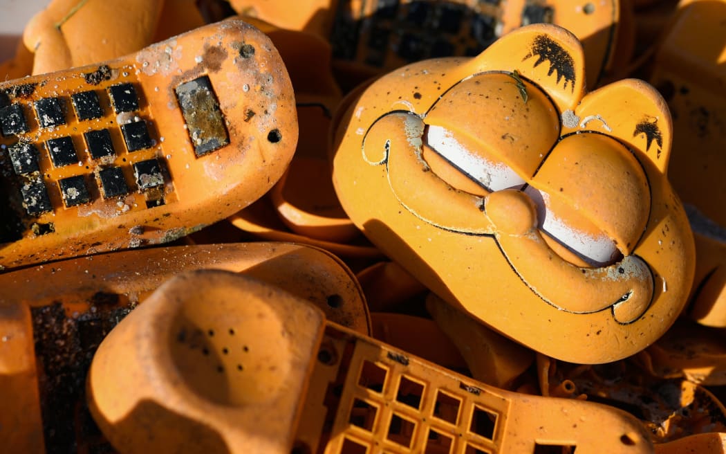 Spare parts of plastic 'Garfield' phones are displayed on the beach in Plouarzel, western France