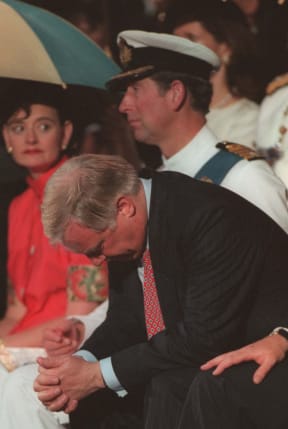Outgoing Governor of Hong Kong Chris Patten, sitting next to Prince Charles, hangs his head in sadness, after delivering his farewell speech at HMS Tamar in Hong Kong 30 June, 1997.