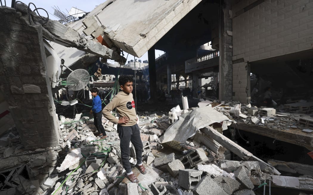 People inspect the damage in the rubble of a mosque following Israeli bombardment, in Rafah, on the southern Gaza Strip on February 12, 2024, amid ongoing battles between Israel and the Palestinian militant group Hamas. (Photo by MOHAMMED ABED / AFP)