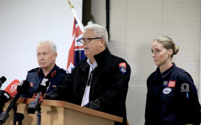 Fire and Emergency chief executive Kerry Gregory (centre) gives an update after a house collapse in Auckland's Muriwai.